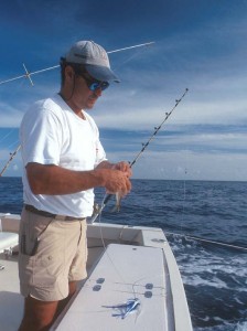 Sea Boots mate Steve Kijak works a ballyhoo onto an Ilander lure rigged for marlin and dolphin. Photo by Chris Dummit.