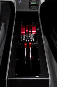 Custom-fabricated Latham Marine throttles and shifters are between the two forward seats.