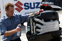 David Greenwood of Suzuki gives a rinsed powerhead a coat of Corrosion Block to protect it from salt-water nastiness.