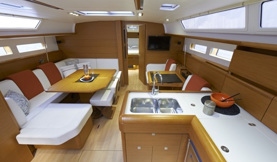 The saloon, shown here with the standard L-shaped galley, is filled with natural light.