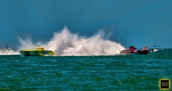 Two canopied catamarans, the piston-powered Miss GEICO and the Qatar-backed turbine-powered Al Adaa'am 96 battle it out on the racecourse in Clearwater, Fla. Photo by Jay Nichols.