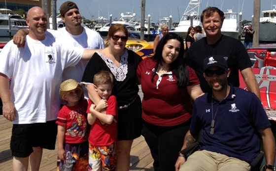 Bob Christie (standing far right) gave rides to more than 30 veterans from the Wounded Warriors Project during the inaugural Atlantic City Festival of Speed. Photo by Tim Sharkey.