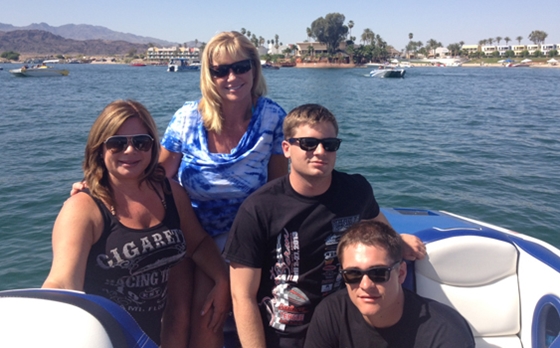 Lisa Ellis (left) Vicki Newton (center) and two Marines caught a ride during the Desert Storm Poker Run with Dan Ellis in his Cigarette V-bottom.