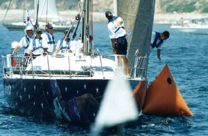Merlin's Reata drifts down into starting line buoy. New owner Al Micallef is under the white Stetson at left. Photo by Rich Roberts