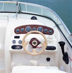 Gold-bezel gauges in a woodgrain panel at the helm are in clear view from the driver's seat with a flip-up bottom.