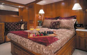 The master suite included a full-size bed and wooden cabinetry.