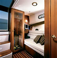 A full-size head compartment &!#8212; with a VacuFlush head, a sink and vanity, a stand-up stall shower and a teak grate &!#8212; is to port.