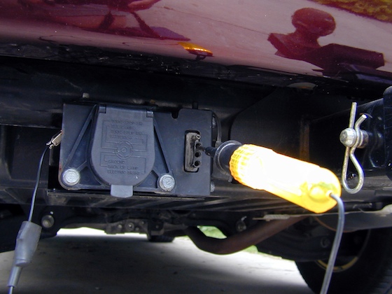 A 12-volt test light can be a handy tool for trouble-shooting trailer light problems. Here the light confirms there is power to the trailer light outlet on the tow vehicle.
