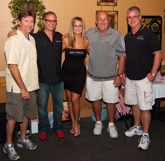 Joy Schou (center) founded the Platinum Powerboat Club to raise money for various charities through its two-day events. Terry Sobo (left) of Nor-Tech “did time” to raise money for the Muscular Dystrophy Association.