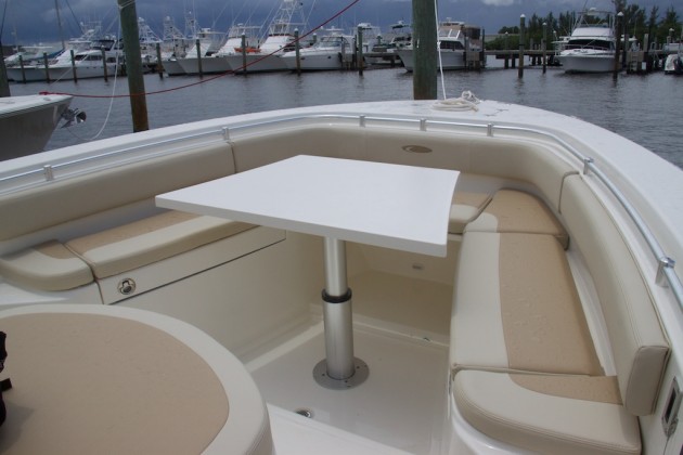 A unique table that raises and lowers electrically means the bow area on the 344 CC can be used for fishing, sun bathing, or dining. Photo: Gary Reich