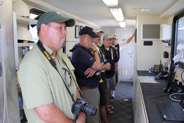 A group of marine journalists scrutinize test results as they are displayed on screen in the Rachel Carson's wet lab area. Photo courtesy of Fortress