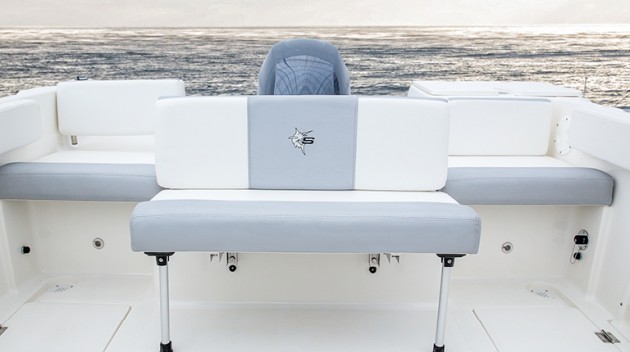 Two jump seats and a flip-up bench provide plenty of seating in the aft cockpit. The seat back for the starboard jumpsuit swivels out of the way to provide easy transom access.