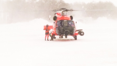 A Coast Guard Air Station Cape Cod helicopter crew returns from rescuing a father and son from a sailboat about 150 miles south of Nantucket. (U.S. Coast Guard photo contributed by Coast Guard Air Station Cape Cod)
