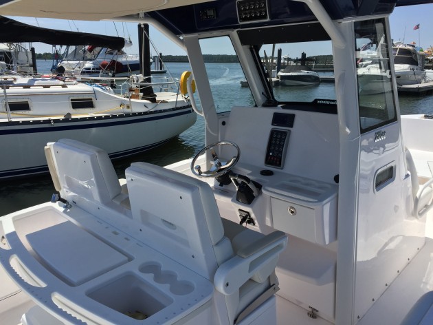 There's plenty of room for all sorts of electronics goodies in the Everglades 295cc's dash. Note the rigging station situated behind the console seating.  Also note the blind spot created by the support pillars in the windshield. Photo by Gary Reich