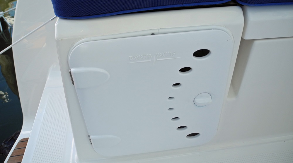New safety standards require propane lockers to be top-loading only. Meanwhile plenty of boats have side-loading lockers like this. If your insurance company has a beef, you might need to get your boatbuilder to send them a letter.