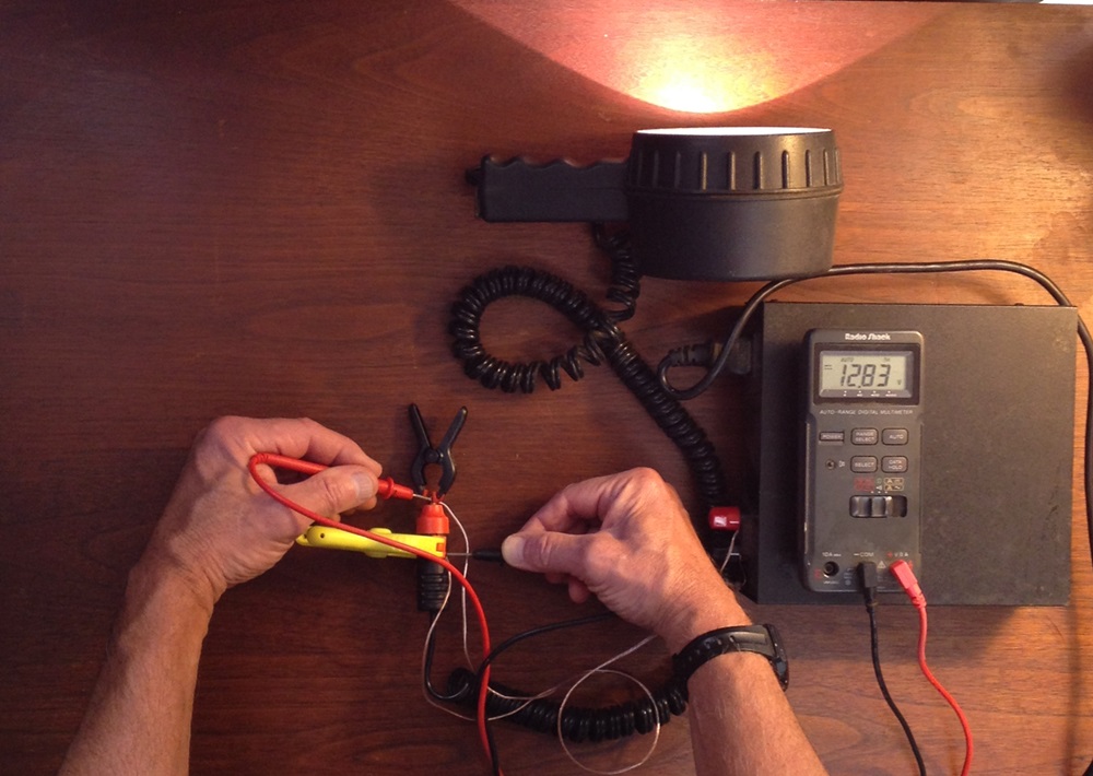 Fig. 4 - When the light is connected to the power supply by undersized wires, there’s an 8.4% drop in voltage – and those undersized wires get quite warm. Also note the reduced output of the light.