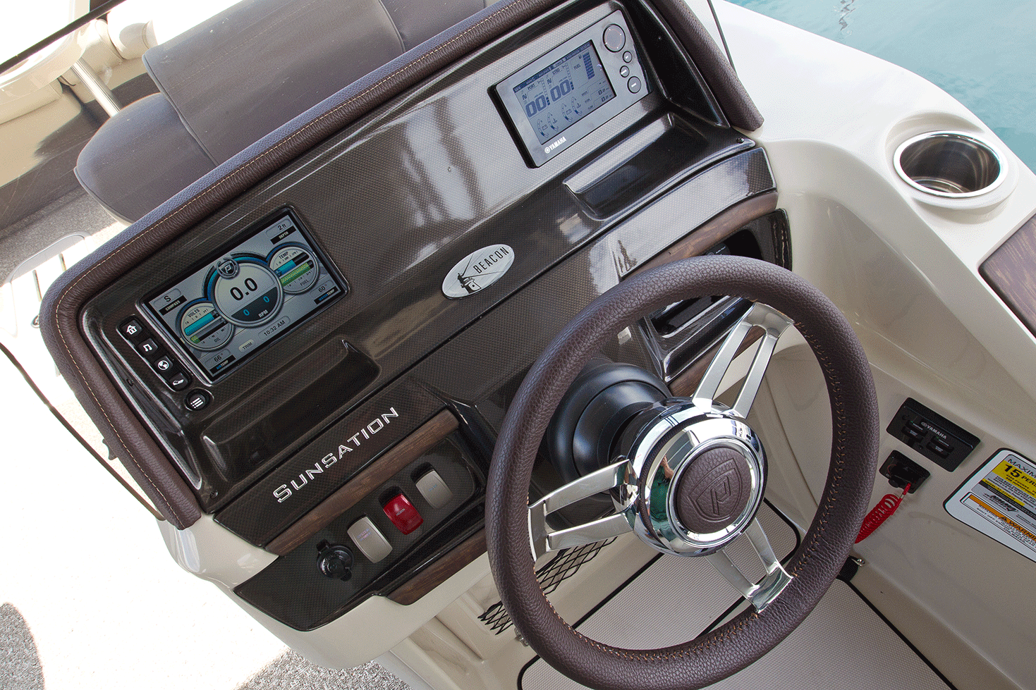 This Premier pontoon boat has all of its systems integrated into an ind=dash touchscreen unit, one of many electronics options available on pontoon boats. 