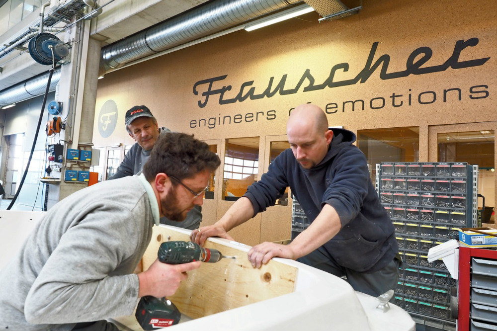 Three workers prepare an aft bench for custom upholstery. Photo © Dieter Loibner.