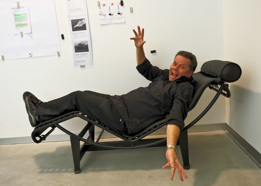 Michael Frauscher waking up from a siesta in his office, right underneath the Kaizen goals that are posted on the wall. Photo © Dieter Loibner.