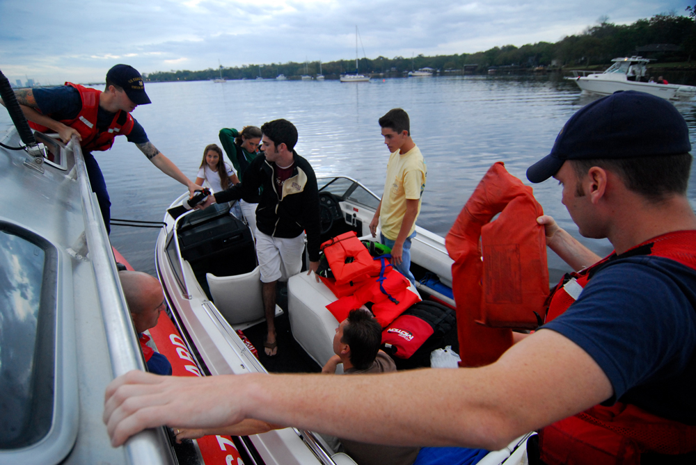 Some safety gear is mandated and other gear is not. Here, the USCG checks a recreational boat to be sure the minimum requirements are met. Photo by Petty Officer 1st Class Bobby Nash, courtesy of USCG.